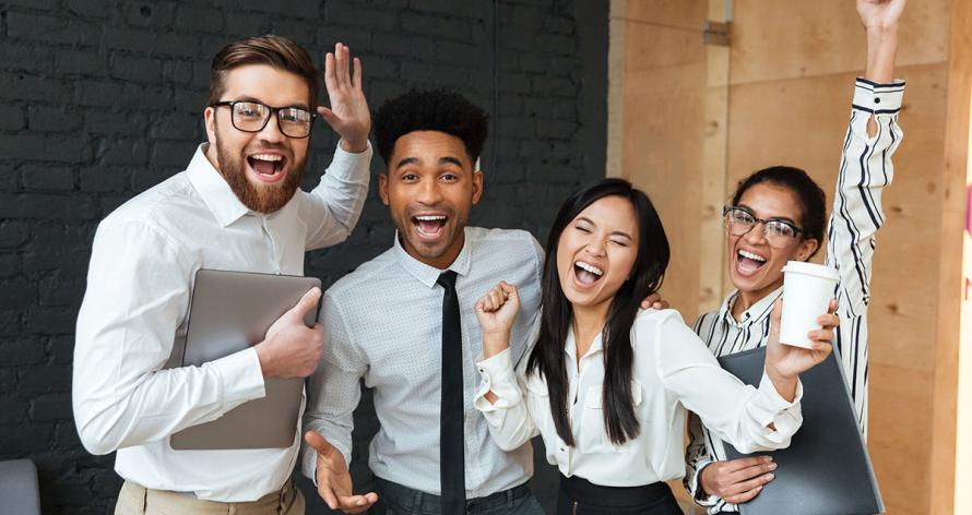 Photo of happy excited young business colleagues indoors coworking. Looking camera make winner gesture.